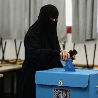 An Arab Israeli casts her ballot in the country’s general election at a polling station in Umm al-Fahm, October 27, 2026. (AP Photo/Mahmoud Illean)