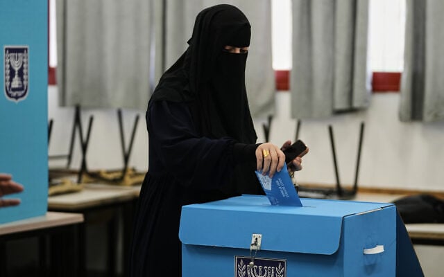 An Arab Israeli casts her ballot in the country’s general election at a polling station in Umm al-Fahm, October 27, 2026. (AP Photo/Mahmoud Illean)