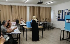 Illustrative: An Arab Israeli woman casts her ballot in the general election at a polling station in Umm al-Fahm, October 27, 2026. (AP Photo/Mahmoud Illean)