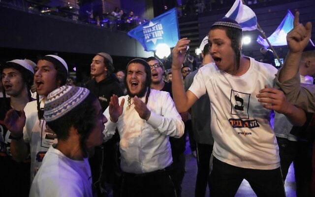 Supporters of Itamar Ben Gvir’s Otzma Yehudit party celebrate after the release of the first exit poll results in Israel’s general election in Modiin, October 27, 2026. (AP Photo/Leo Correa)