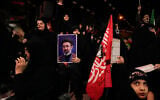 Demonstrators chant slogans as one holds a portrait of the Iranian Supreme Leader Ayatollah Mojtaba Khamenei during a pro-government gathering in Tehran, Iran, October 27, 2026. (AP Photo/Vahid Salemi)