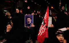 Demonstrators chant slogans as one holds a portrait of the Iranian Supreme Leader Ayatollah Mojtaba Khamenei during a pro-government gathering in Tehran, Iran, October 27, 2026. (AP Photo/Vahid Salemi)