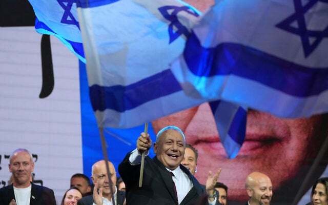 Gadi Eisenkot, leader of the Yashar party, waves an Israeli flag after the release of the first exit poll results in Israel’s general election in Tel Aviv, Israel, October 28, 2026. (AP Photo/Ariel Schalit)