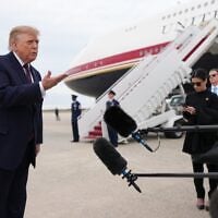 US President Donald Trump speaks to reporters before boarding Air Force One, October 28, 2026, at Joint Base Andrews, Maryland. (AP Photo/Mark Schiefelbein)
