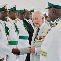 Britain’s King Charles III meets officers at the Royal Bahamas Defence Force Base in Nassau, Bahamas, October 28, 2026. (AP Photo/Tim Aylen)