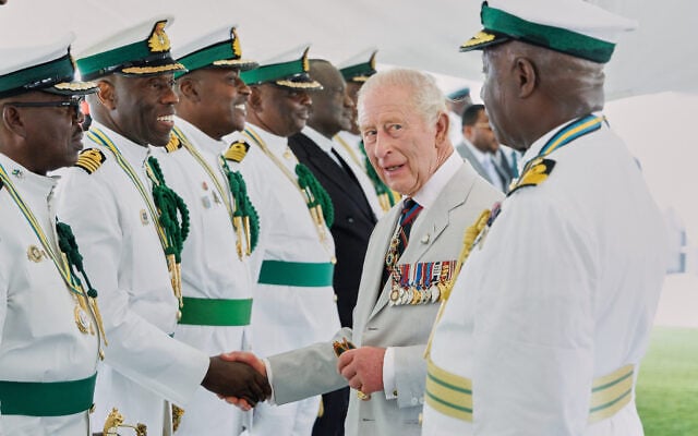 Britain’s King Charles III meets officers at the Royal Bahamas Defence Force Base in Nassau, Bahamas, October 28, 2026. (AP Photo/Tim Aylen)
