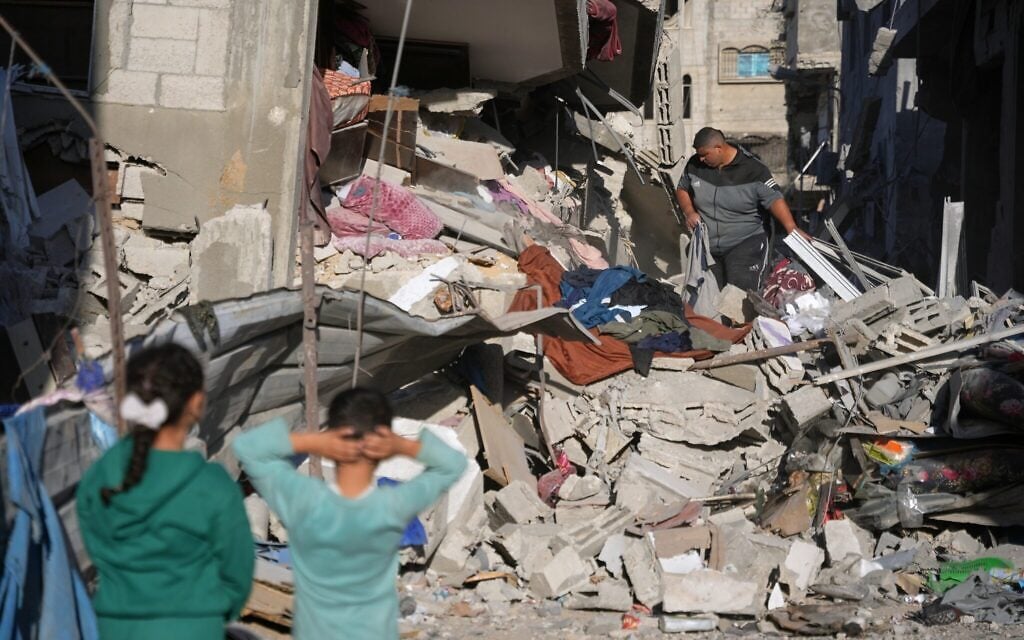Palestinians search through the rubble of a building destroyed in an overnight Israeli strike in the Bureij refugee camp, in the central Gaza Strip, October 30, 2026. (AP Photo/Abdel Kareem Hana) Palestinians search through the rubble of a building destroyed in an overnight Israeli strike in the Bureij refugee camp, in the central Gaza Strip, October 30, 2026. (AP Photo/Abdel Kareem Hana)