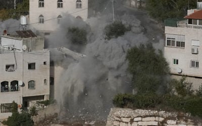 Smoke, dust and debris rise as the Israeli army demolishes two houses with explosives in connection with an October 23 shooting attack that killed two Israeli soldiers, in the West Bank city of Hebron, October 30, 2026. (AP/Mahmoud Illean) Smoke, dust and debris rise as the Israeli army demolishes two houses with explosives in connection with an October 23 shooting attack that killed two Israeli soldiers, in the West Bank city of Hebron, October 30, 2026. (AP/Mahmoud Illean)