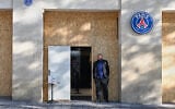 A man stands in front of a barricaded shop of the soccer team Paris Saint-Germain before protests in Paris, France, October 31, 2026. (AP Photo/Emma Da Silva)
