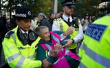 Police officers arrest a protester during a demonstration in support of Palestine Action, outside the US embassy, in London, October 31, 2026. (AP Photo/Alberto Pezzali)