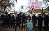 A demonstrator holds a poster reading 'Tusk go to Berlin' during a protest in front of the Polish Constitutional Court in Warsaw, Poland, October 31, 2026. (Beata Zawrzel/AP)