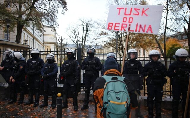 A demonstrator holds a poster reading 'Tusk go to Berlin' during a protest in front of the Polish Constitutional Court in Warsaw, Poland, October 31, 2026. (Beata Zawrzel/AP)