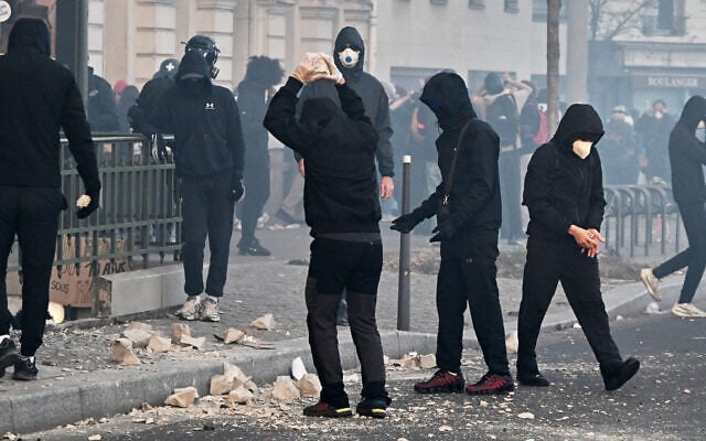 Demonstrators prepare stones during protests in Paris, France, October 31, 2026. (AP Photo/Emma Da Silva) Demonstrators prepare stones during protests in Paris, France, October 31, 2026. (AP Photo/Emma Da Silva)