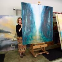 Barbara Hines with one of her paintings in Jerusalem. (Courtesy/Tom DuBrock)