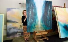 Barbara Hines with one of her paintings in Jerusalem. (Courtesy/Tom DuBrock)