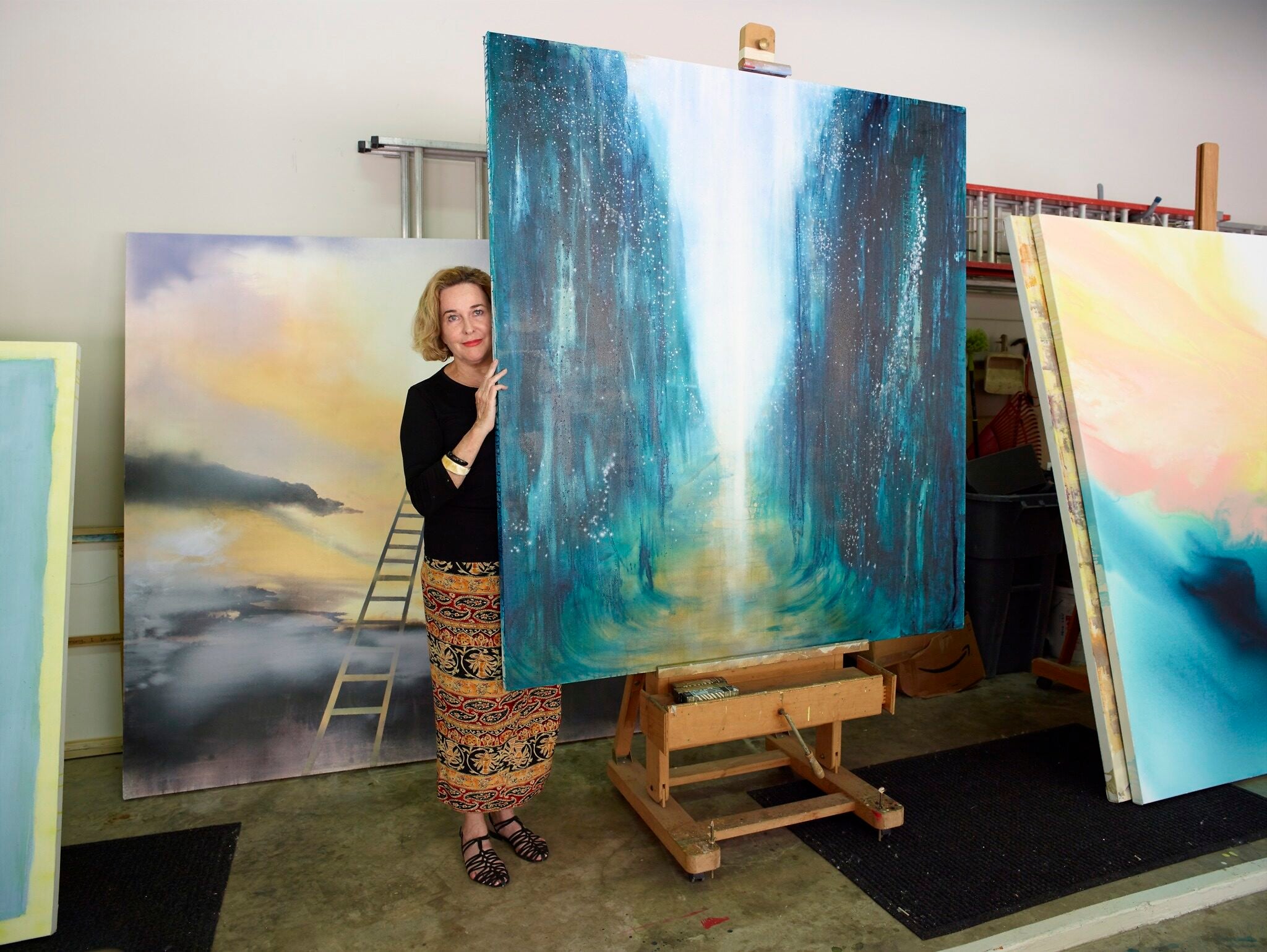 Barbara Hines with one of her paintings in Jerusalem. (Courtesy/Tom DuBrock) Barbara Hines with one of her paintings in Jerusalem. (Courtesy/Tom DuBrock)