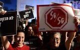 Women hold signs as they protest for women's equality, in Tel Aviv, on August 23, 2022. (Tomer Neuberg/FLASH90)
