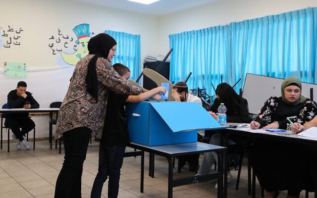 Illustrative: Arab Israelis cast their vote at a voting station in Tayibe, during the Knesset Elections, on November 1, 2022. (Jamal Awad/Flash90)