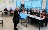 Arab Israelis cast their vote at a voting station in Tayibe, during the Knesset election on November 1, 2022. (Jamal Awad/Flash90)