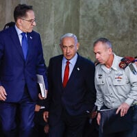 Prime Minister Benjamin Netanyahu arrives for a cabinet meeting at the Prime Minister’s Office in Jerusalem on January 22, 2023. At right is his military secretary, Maj. Gen. Avi Gil. At left is his chief of staff Tzachi Braverman. (Olivier Fitoussi/FLASH90)