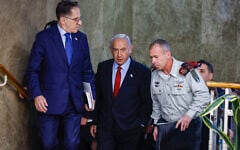 Prime Minister Benjamin Netanyahu arrives for a cabinet meeting at the Prime Minister’s Office in Jerusalem on January 22, 2023. At right is his military secretary, Maj. Gen. Avi Gil. At left is his chief of staff Tzachi Braverman. (Olivier Fitoussi/FLASH90)