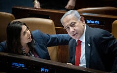 Prime Minister Benjamin Netanyahu with Minister of Transportation Miri Regev in the Knesset on February 20, 2023. (Yonatan Sindel/Flash90)