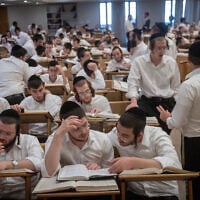 Yeshiva students study at the Kamenitz Yeshiva in Jerusalem on August 19, 2026. (Chaim Goldberg/Flash90)