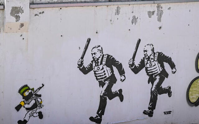 A mural titled “RUN” by artist aleXsandro Palombo depicts Prime Minister Benjamin Netanyahu and Gadi Eisenkot wearing bulletproof vests and carrying batons as they chase Bart Simpson, portrayed as a young Hamas terrorist, in Tel Aviv on September 29, 2026. (Avshalom Sassoni/Flash90)