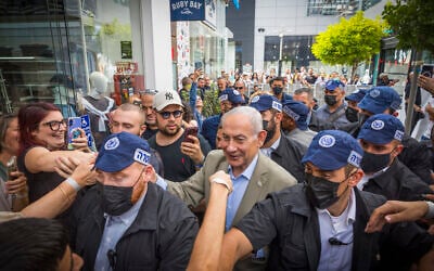 Prime Minister Benjamin Netanyahu, surrounded by supporters, during an election campaign tour in Ashdod, September 29, 2026. (Liron Moldovan/Flash90)