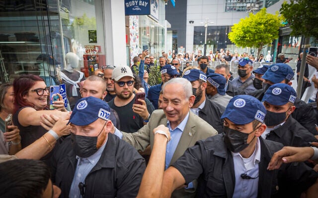 Prime Minister Benjamin Netanyahu, surrounded by supporters, during an election campaign tour in Ashdod, September 29, 2026. (Liron Moldovan/Flash90)