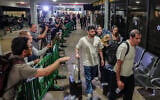 Passengers from flydubai flight FZ1073 walk with their family members through the arrivals hall at Ben Gurion International Airport near Tel Aviv, September 30, 2026. (Flash90)