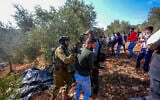 Israeli security forces remove Palestinians and left-wing activists from olive groves during the olive harvest season in the West Bank village of Beita, near Nablus, October 2, 2026. (Flash90)