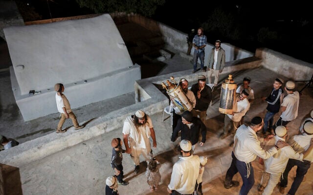 Worshippers celebrate the Jewish holiday of Simhat Torah under heavy Israeli military security at what is believed to be the tomb of Itamar, son of Aaron the High Priest, in the Palestinian village of Awarta, near Nablus in the West Bank, October 3, 2026. (Hilel Ben Or/Flash90)