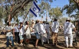 Worshipers celebrate the Jewish holiday of Simchat Torah at the site of the Nova music festival, where hundreds of people were murdered by Hamas during the October 7 massacre, near Kibbutz Re’im in southern Israel, October 3, 2026. (Tsafrir Abayov/Flash90)