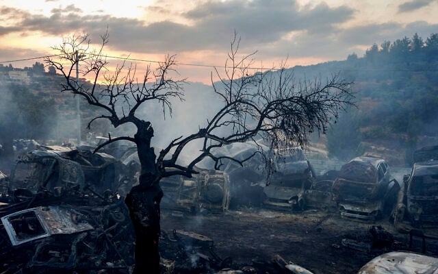 Illustrative: Palestinian firefighters extinguish a fire at a scrapyard following an alleged attack by extremist Israeli settlers in the Palestinian village of Ein Yabrud, near Ramallah in the West Bank, October 4, 2026. (Flash90)