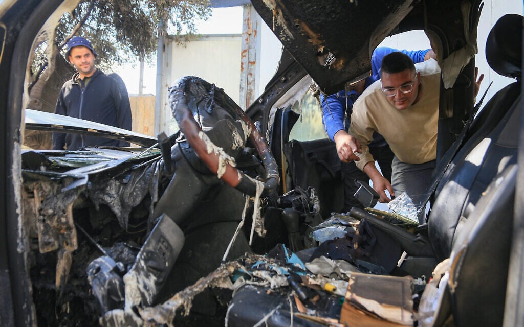 Palestinians inspect the damage after extremist Jewish settlers allegedly set fire to four vehicles and sprayed Hebrew graffiti on the walls of homes in the Palestinian village of Aqraba, south of Nablus in the West Bank, October 6, 2026. (Nasser Ishtayeh/Flash90) Palestinians inspect the damage after extremist Jewish settlers allegedly set fire to four vehicles and sprayed Hebrew graffiti on the walls of homes in the Palestinian village of Aqraba, south of Nablus in the West Bank, October 6, 2026. (Nasser Ishtayeh/Flash90)