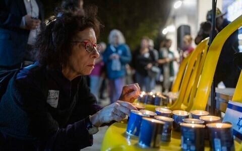 People light candles in memory of the victims of the October 7 massacre during a memorial ceremony at Paris Square in Jerusalem, October 6, 2026. (Yonatan Sindel/Flash90)