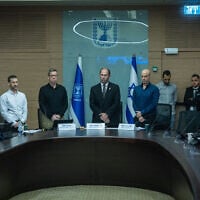 Members of the Knesset Constitution, Law and Justice Committee observe a minute of silence in memory of those murdered in the October 7, 2023 massacre, during a committee hearing, October 7, 2026. (Chaim Goldberg/Flash90)
