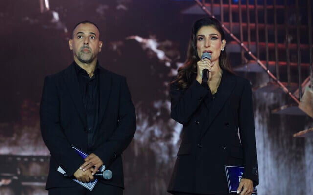 Former hostage Eli Sharabi and actress Shani Cohen host the national memorial ceremony marking three years since the October 7 massacre, at Yarkon Park in Tel Aviv, October 7, 2026. (Miriam Alster/Flash90) Former hostage Eli Sharabi and actress Shani Cohen host the national memorial ceremony marking three years since the October 7 massacre, at Yarkon Park in Tel Aviv, October 7, 2026. (Miriam Alster/Flash90)