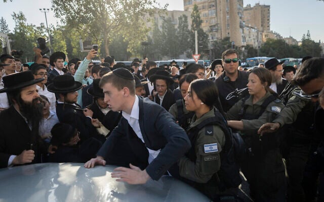 Ultra-Orthodox Jewish men block a road and clash with police during a protest against the jailing of yeshiva students who failed to comply with an army recruitment order, in Jerusalem, October 8, 2026. (Chaim Goldberg/Flash90)