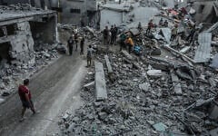 Palestinians inspect the damage following an Israeli airstrike in Khan Yunis, in the southern Gaza Strip, October 9, 2026. (Abed Rahim Khatib/Flash90)