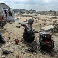 Displaced Palestinians living in a cemetery in central Khan Younis, in the southern Gaza Strip, after being unable to return to their homes, which were destroyed during the war between Israel and Hamas, October 10, 2026. (Abed Rahim Khatib/Flash90)