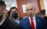 Prime Minister Benjamin Netanyahu, right, arrives for a hearing in his corruption trial at the Jerusalem District Court on October 11, 2026. (Chaim Goldberg/ Flash90)