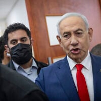 Prime Minister Benjamin Netanyahu, right, arrives for a hearing in his corruption trial at the Jerusalem District Court on October 11, 2026. (Chaim Goldberg/ Flash90)