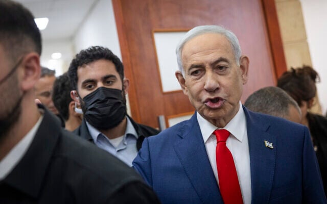 Prime Minister Benjamin Netanyahu, right, arrives for a hearing in his corruption trial at the Jerusalem District Court on October 11, 2026. (Chaim Goldberg/ Flash90)