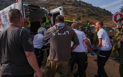 Israeli security and rescue forces evacuate injured people near the site where unexploded ordnance detonated during a school trip, near Kibbutz Yiftah in the Ramim Ridge area, close to the Israeli border with Lebanon, October 12, 2026. (Ayal Margolin/Flash90)