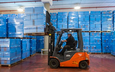 Workers prepare ballot boxes for Israel’s upcoming general elections at the Central Elections Committee warehouse in Shoham, ahead of their distribution to polling stations across the country, October 14, 2026. (Yonatan Sindel/Flash90)