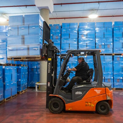 Workers prepare ballot boxes for Israel’s upcoming general elections at the Central Elections Committee warehouse in Shoham, ahead of their distribution to polling stations across the country, October 14, 2026. (Yonatan Sindel/Flash90)