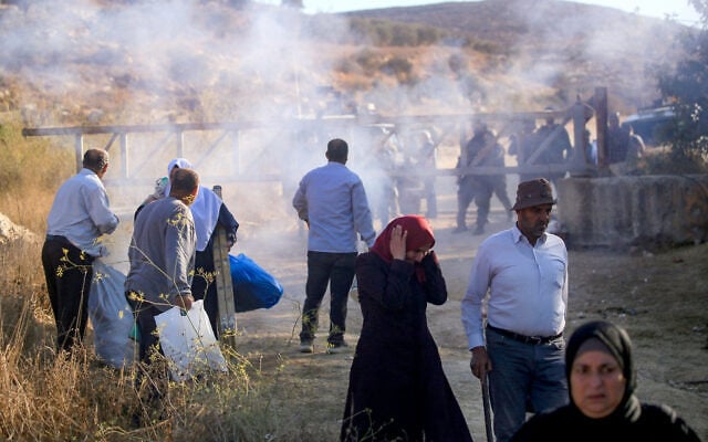 Israeli security forces fire tear gas and disperse Palestinian farmers, preventing them from continuing the olive harvest as they attempt to cross an iron gate erected by the army in the village of Salem, east of Nablus in the West Bank, October 17, 2026. (Nasser Ishtayeh/Flash90)