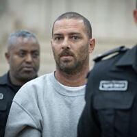 Pinhas Shem Tov Ran, a civilian security coordinator accused of shooting and seriously wounding a Palestinian woman in the West Bank, arrives at the Jerusalem District Court following his indictment, October 23, 2026. (Flash90)
